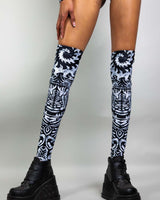 Archaic leg sleeves in black and white pattern, styled with chunky black platform boots, perfect for rave outfits.