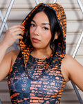 Model wearing Atomic Assassin Hood in orange and black post-apocalyptic design.
