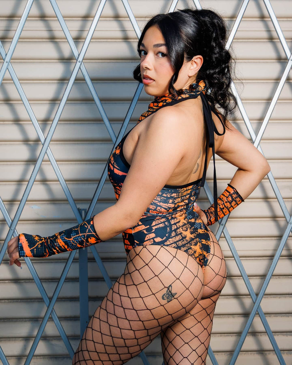 Model wearing Atomic Gloves and Blaze outfit with flame-meets-galaxy print for rave fashion