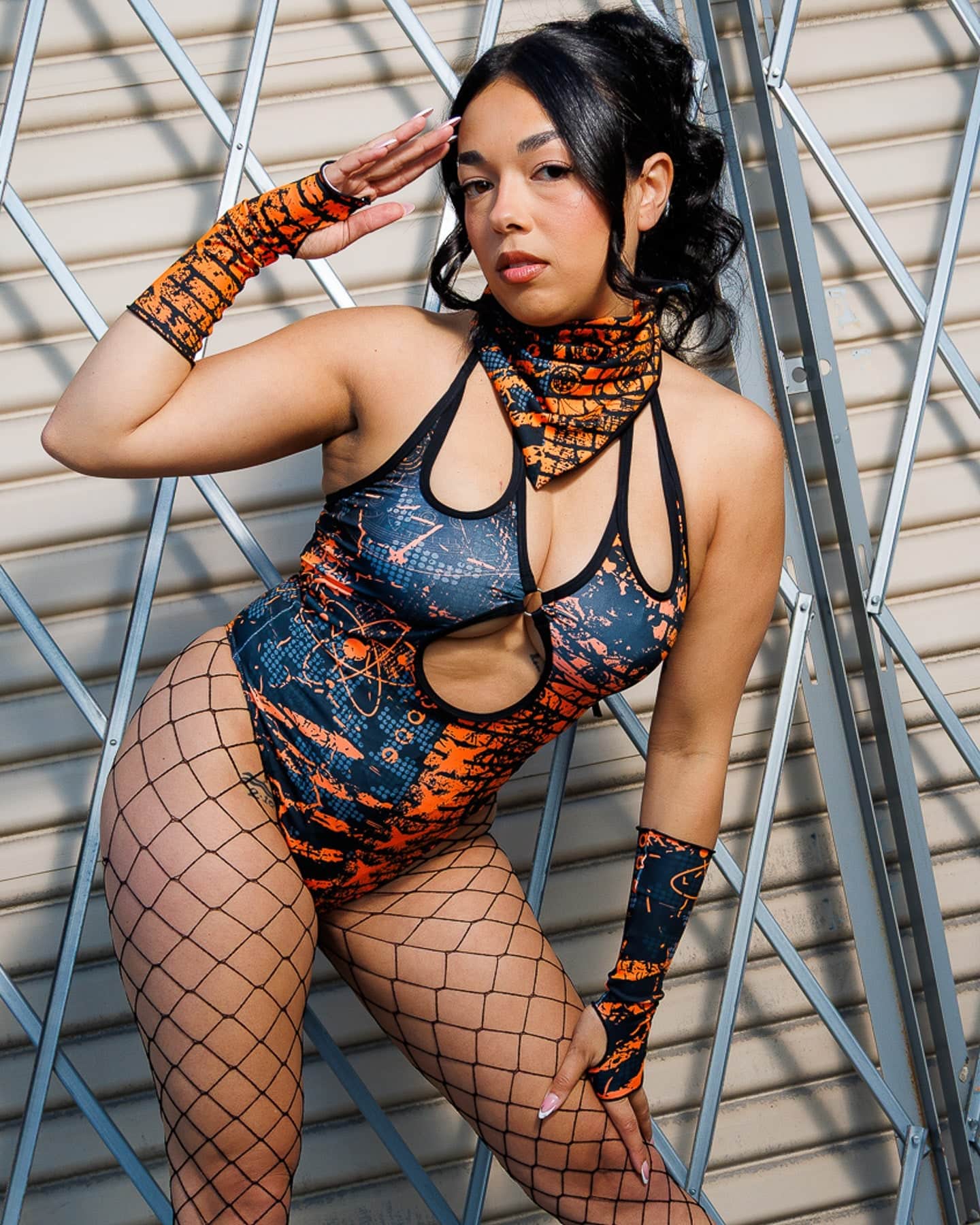 Model wearing Atomic Gloves with flame-meets-galaxy print, fingerless design. Perfect for rave energy and style.
