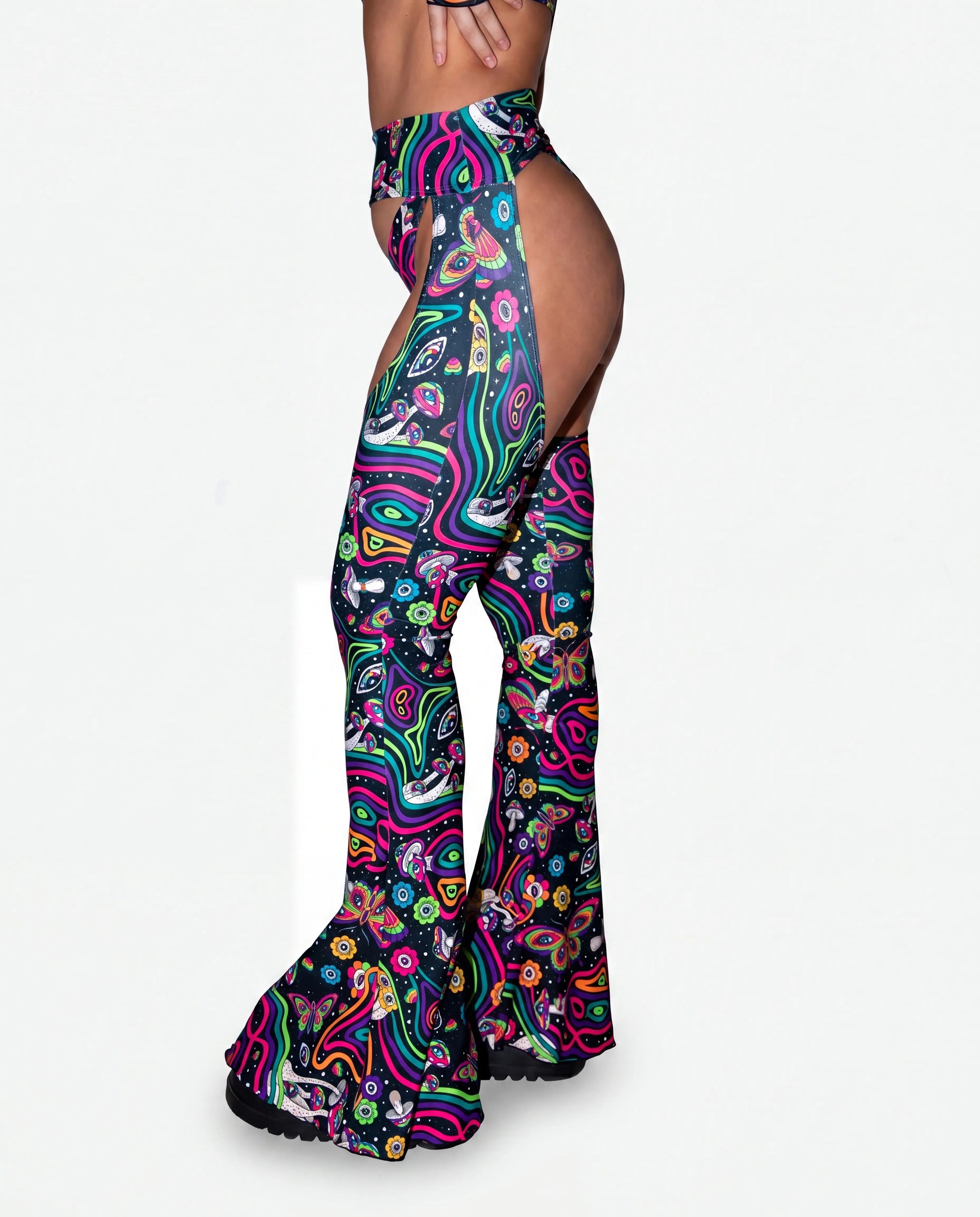 Awaken Bell Chaps from the back, featuring a vibrant psychedelic pattern with mushrooms and eyes, perfect for a rave festival. — cyc_2