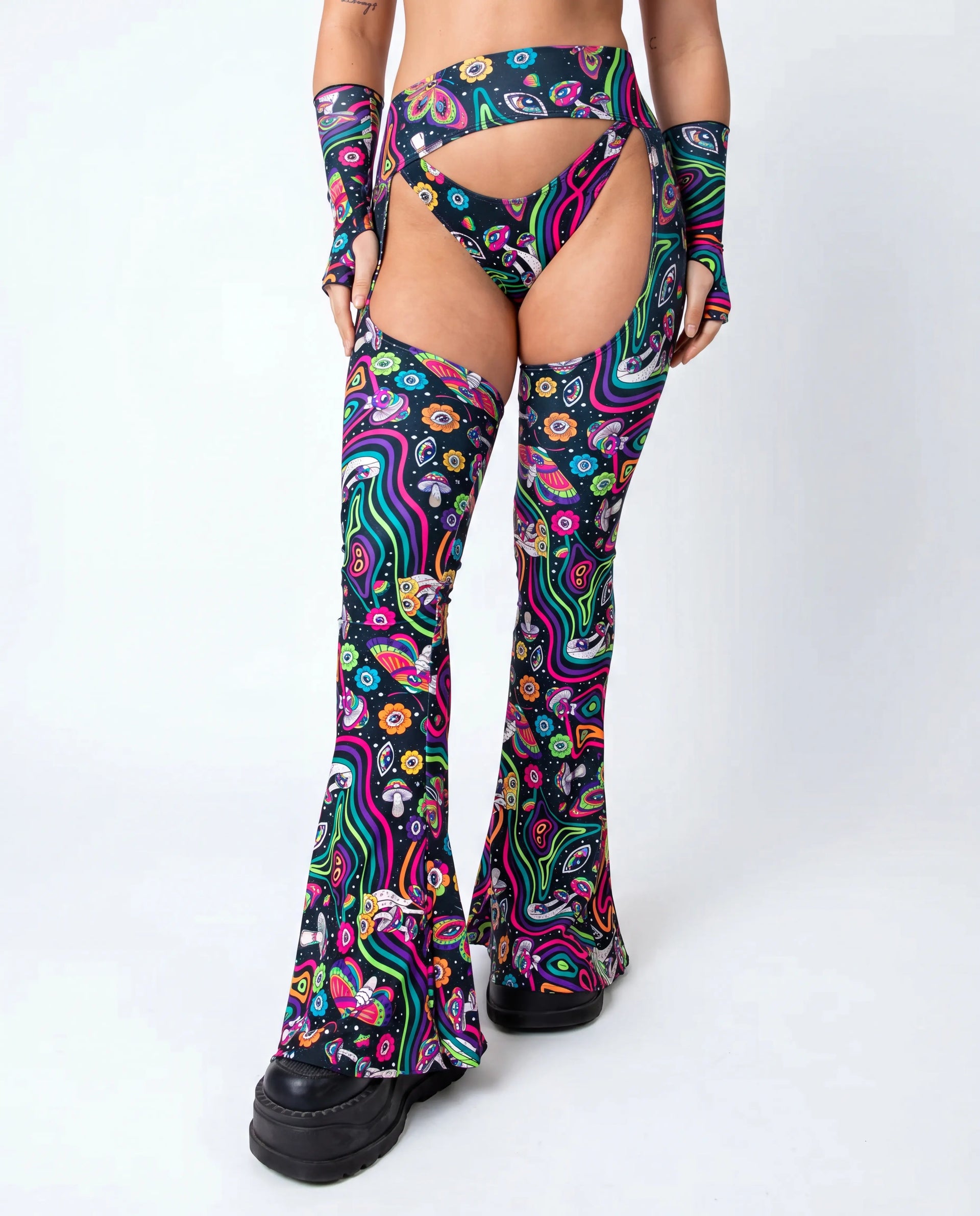Awaken Bell Chaps from the back, featuring a vibrant psychedelic pattern with mushrooms and eyes, perfect for a rave festival. — cyc_3