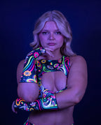 Awaken Gloves on a model, front view, showcasing the vibrant multi-color psychedelic pattern with cosmic eyes and florals, perfect for rave festivals. — uv