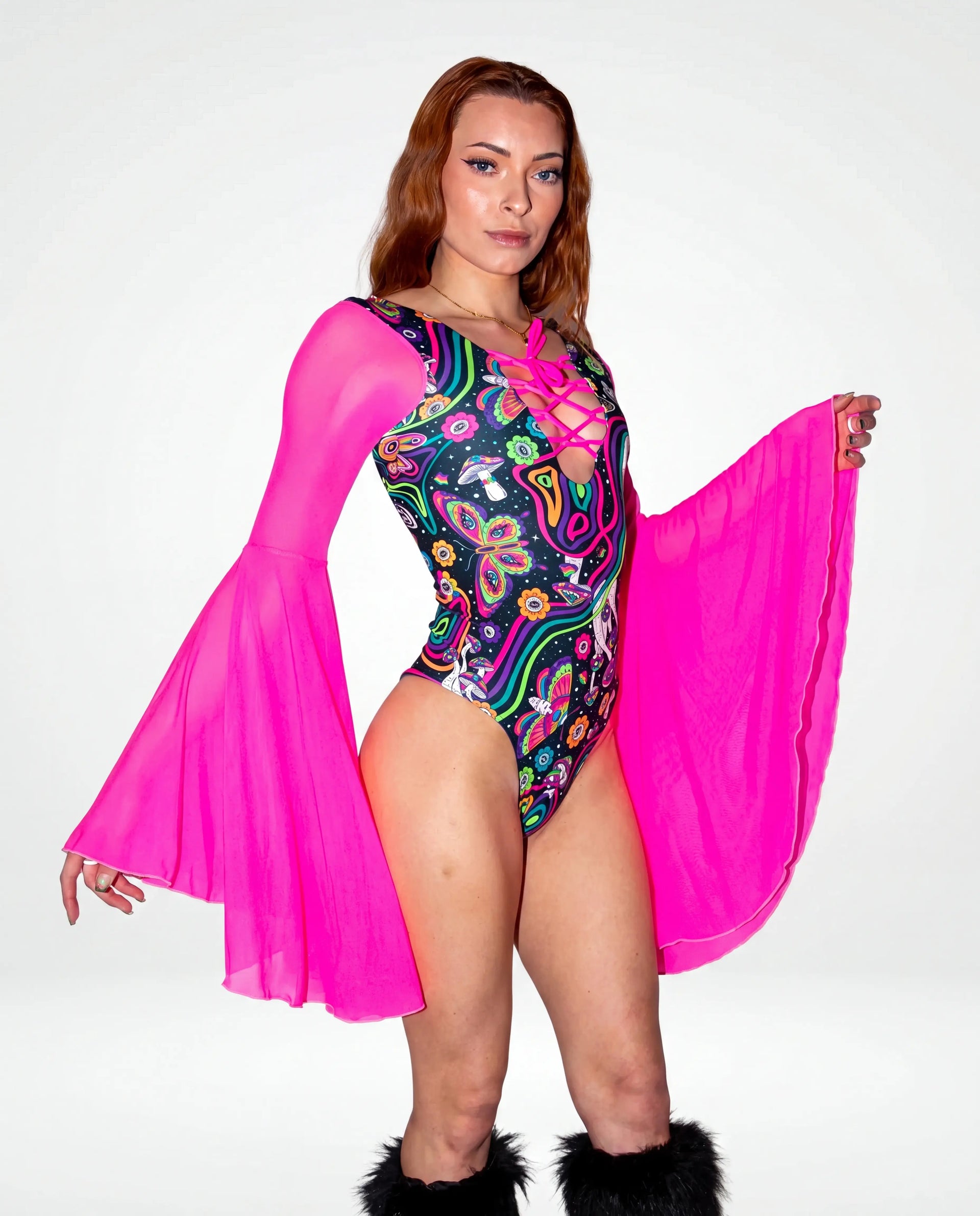 Awaken Goddess Bodysuit front view, featuring a colorful psychedelic pattern and sheer neon pink bell sleeves, perfect for a rave or festival. — cyc_5