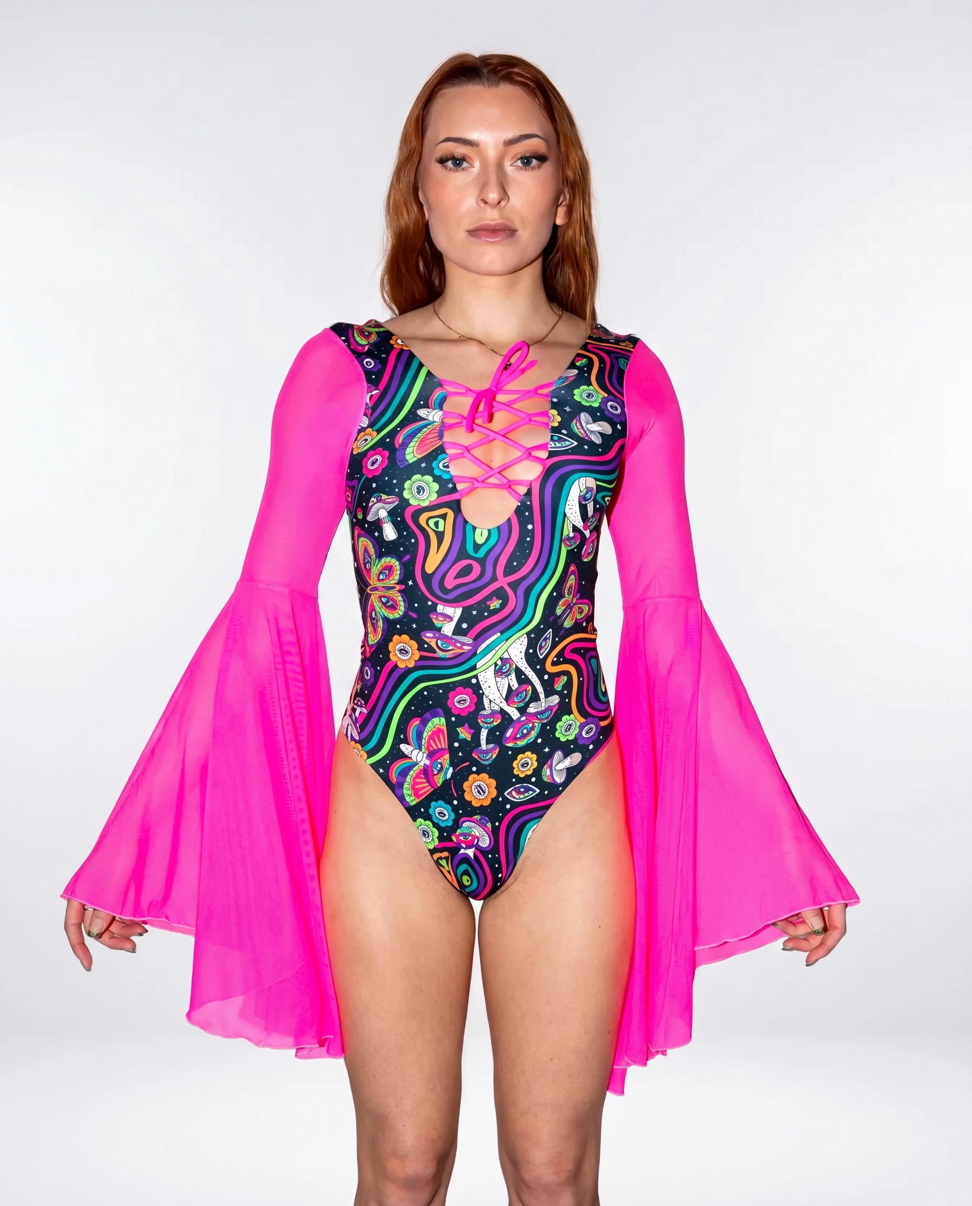 Awaken Goddess Bodysuit front view, featuring a colorful psychedelic pattern and sheer neon pink bell sleeves, perfect for a rave or festival. — cyc_6