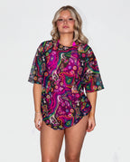 Awaken Mesh Oversized Tee front view, a vibrant psychedelic rave top with a black belt and silver chains. — cyc_5