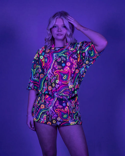 Awaken Mesh Oversized Tee front view, a vibrant psychedelic rave top with a black belt and silver chains. — uv