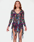 Awaken Sea Fairy Tie Top shown from the front on a model, featuring a sheer, long-sleeved, psychedelic multi-color rave top over a pink bodysuit. — cyc_6