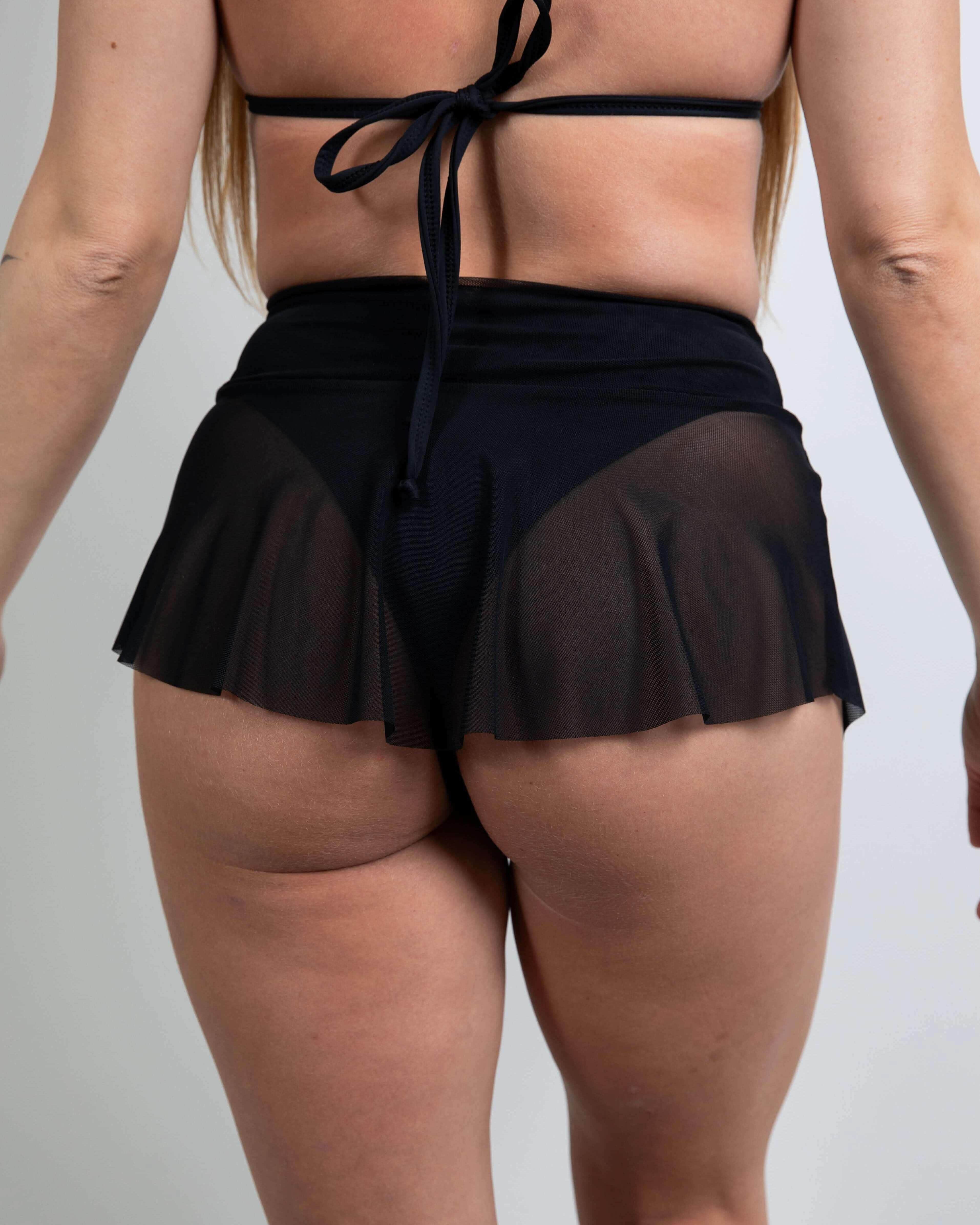 Black mesh micro skater skirt back view, highlighting lightweight design perfect for rave outfits.
