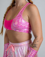 Pink holographic rave top with mesh detail, perfect for festival outfits and summer parties.