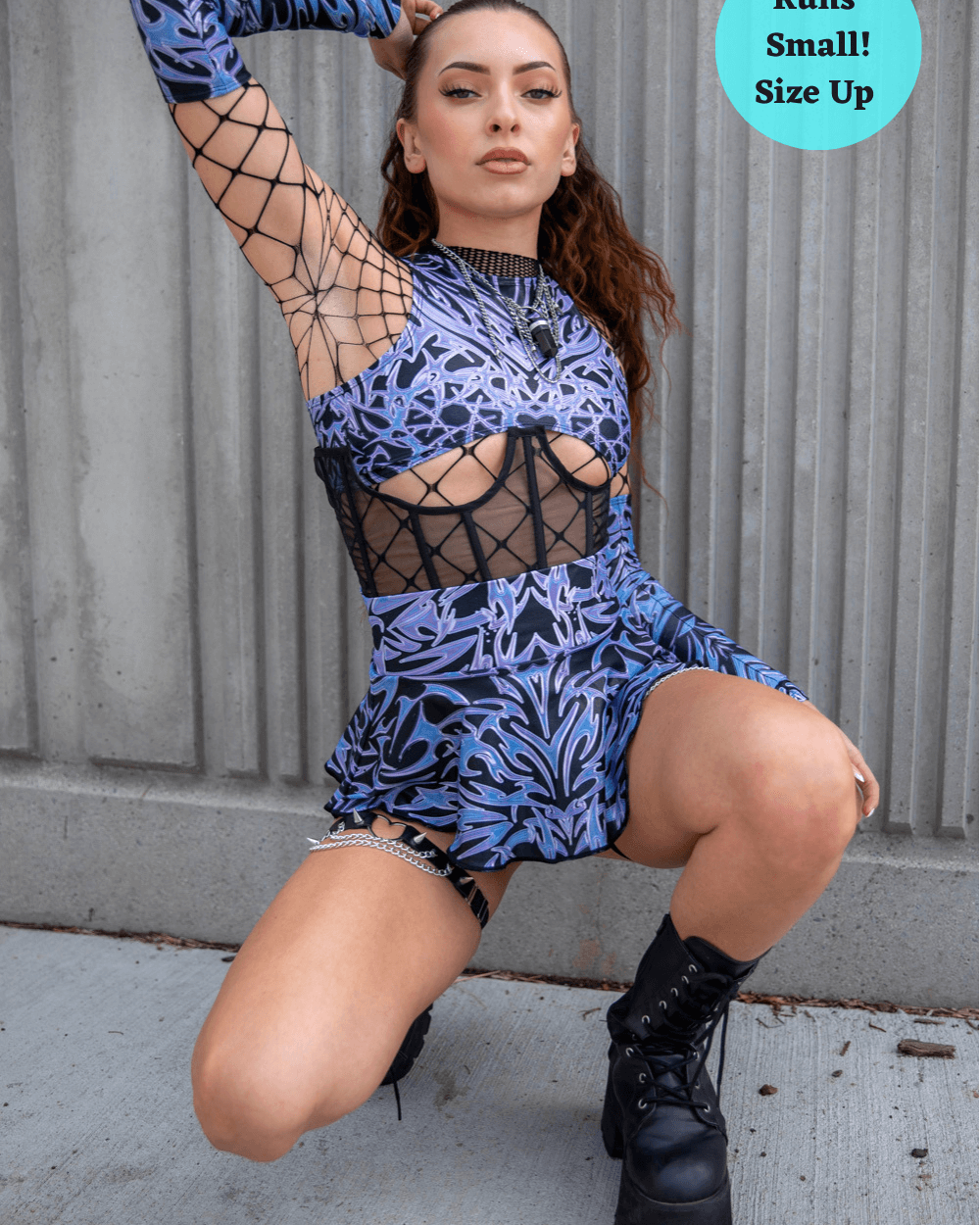 Model wearing a Chromium Micro Skater Skirt showcasing rave outfits in a bold cyber design, perfect for street style.