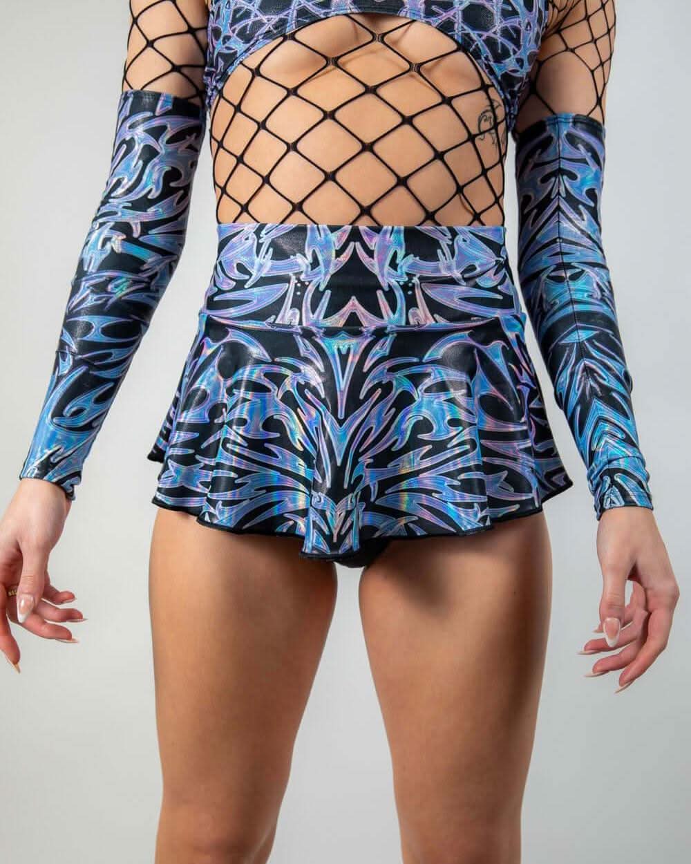 Chromium holographic rave skirt with fishnet overlay styled on model from front view for festival outfit