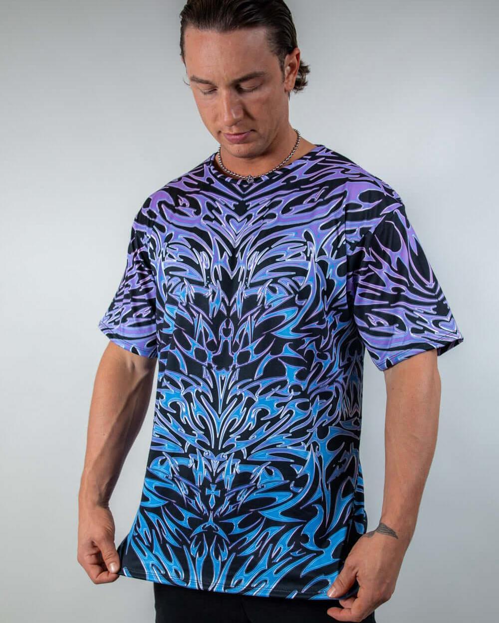 Model showcasing the Chromium Oversized Softee from a slight angle, highlighting its relaxed, draped fit and bold holographic design.