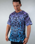 Model showcasing the Chromium Oversized Softee from a slight angle, highlighting its relaxed, draped fit and bold holographic design.
