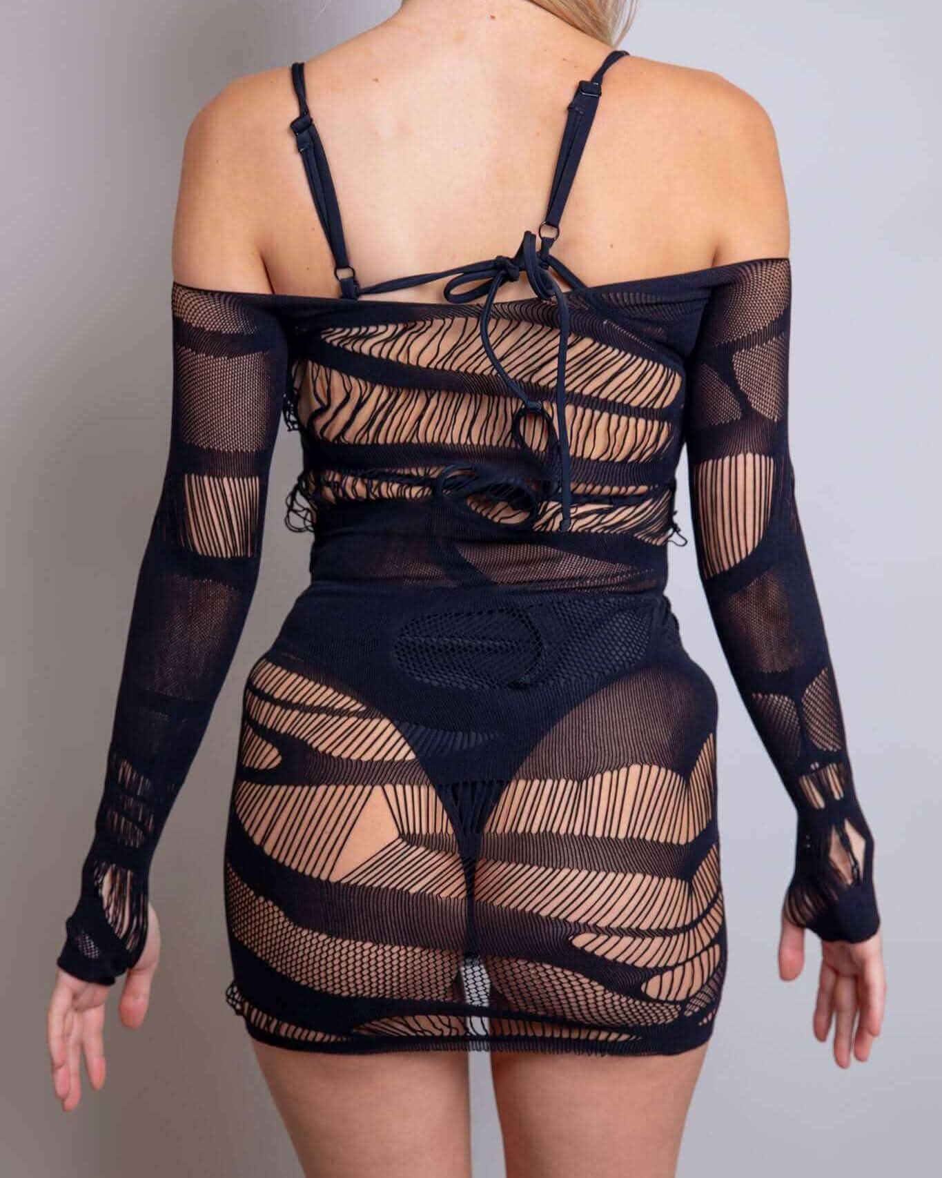 Back view of the Dark Dimensions Fishnet Dress showcasing its edgy design and off-the-shoulder style, perfect for rave outfits.