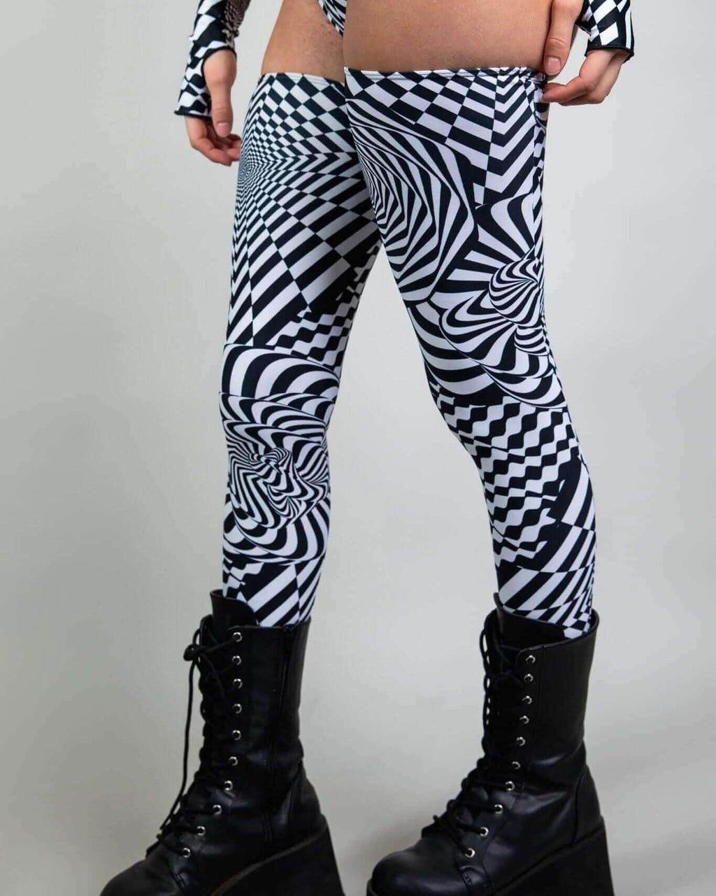Distortion leg sleeves featuring an abstract optical labyrinth design, perfect for rave outfits and festival fashion.