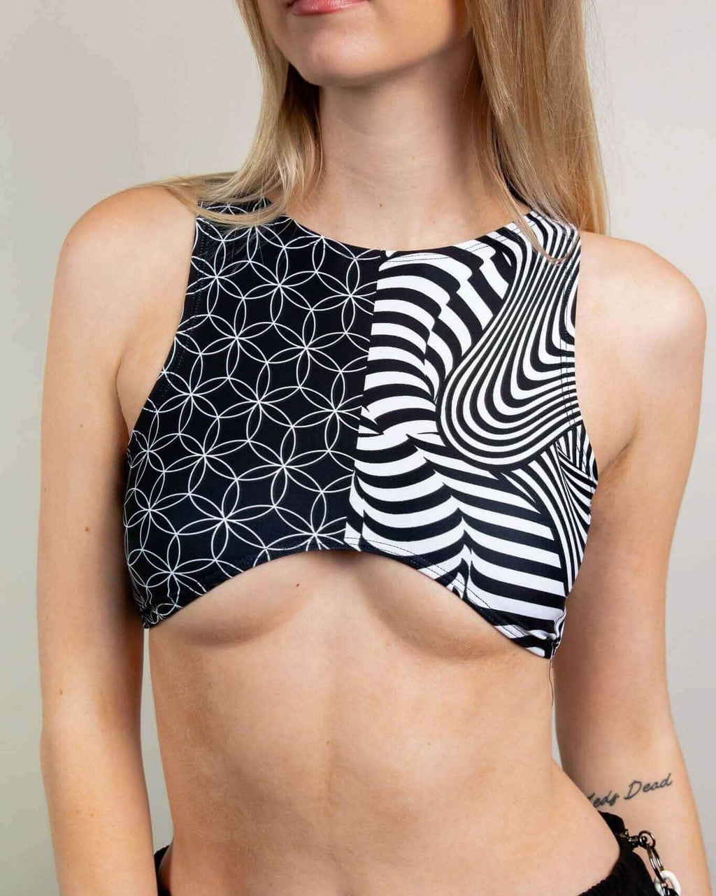 Model wearing Duality Teaser Top, a stylish crop with unique patterns, perfect for rave outfits and made from recycled materials.