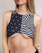 Model wearing Duality Teaser Top, a stylish crop with unique patterns, perfect for rave outfits and made from recycled materials.