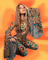 Model in a psychedelic swirl-patterned jumpsuit poses confidently against an orange gradient background, embodying rave fashion.