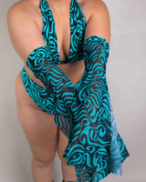 Model showcasing Enigma Metamorphosis Sleeves in vibrant blue swirls, perfect for rave outfits and festival style.