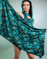 Model showcasing the Faewood Festival Scarf, a vibrant, hooded scarf with a whimsical tree design, perfect for rave outfits.