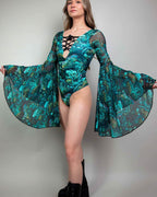 Faewood Goddess rave bodysuit with flowing bell sleeves in teal coral print, model front pose festival outfit