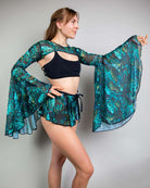 Model wearing Faewood Mesh Bell Sleeves with colorful floral pattern, styled for rave outfits.