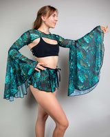 Model wearing Faewood Mesh Bell Sleeves with colorful floral pattern, styled for rave outfits.