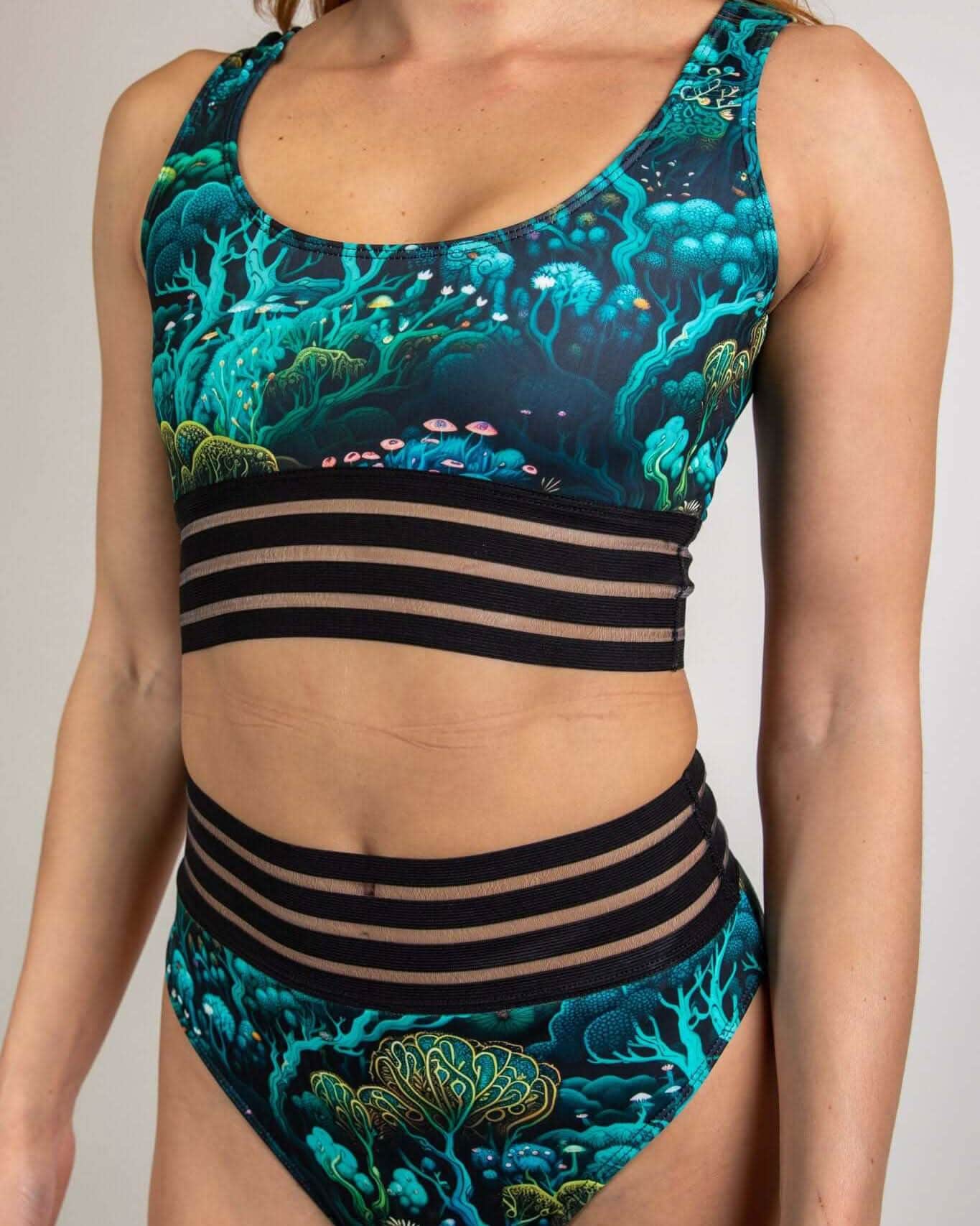 Faewood rave top with matching bottoms featuring teal mystical print and black elastic strapping details front view
