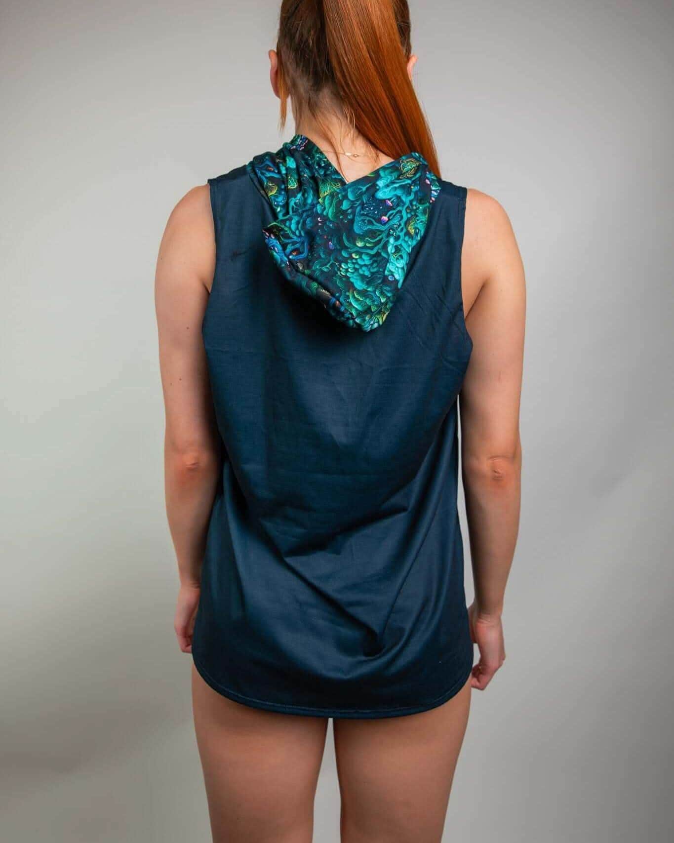 Back view of a woman wearing the Faewood Tank Top with Hood, showcasing its vibrant hood design for rave outfits.