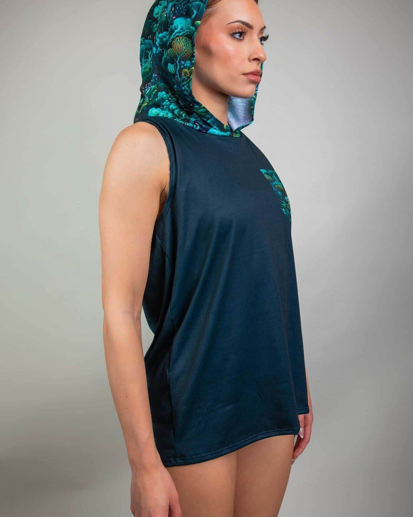 Woman modeling Faewood Tank Top with Hood featuring vibrant enchanted forest design, perfect for rave outfits.