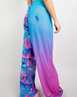 Model wearing Fairycore Mesh Lucy Pants with colorful mushroom print and gradient design, perfect for rave outfits.