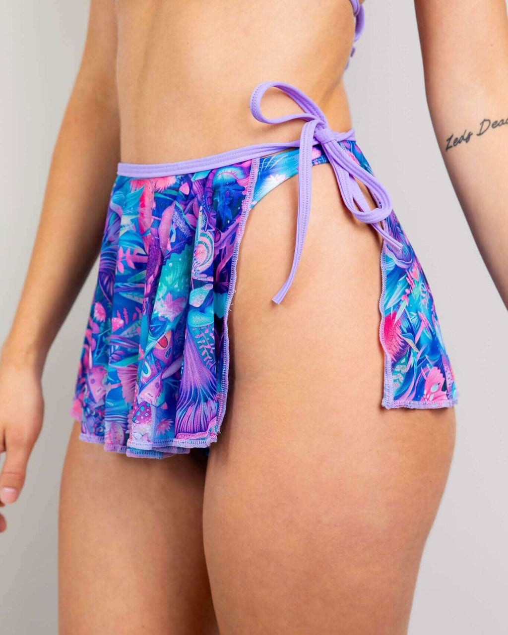 Fairycore mesh swirl skirt in vibrant colors, designed for layering with swimwear, ideal for rave outfits.