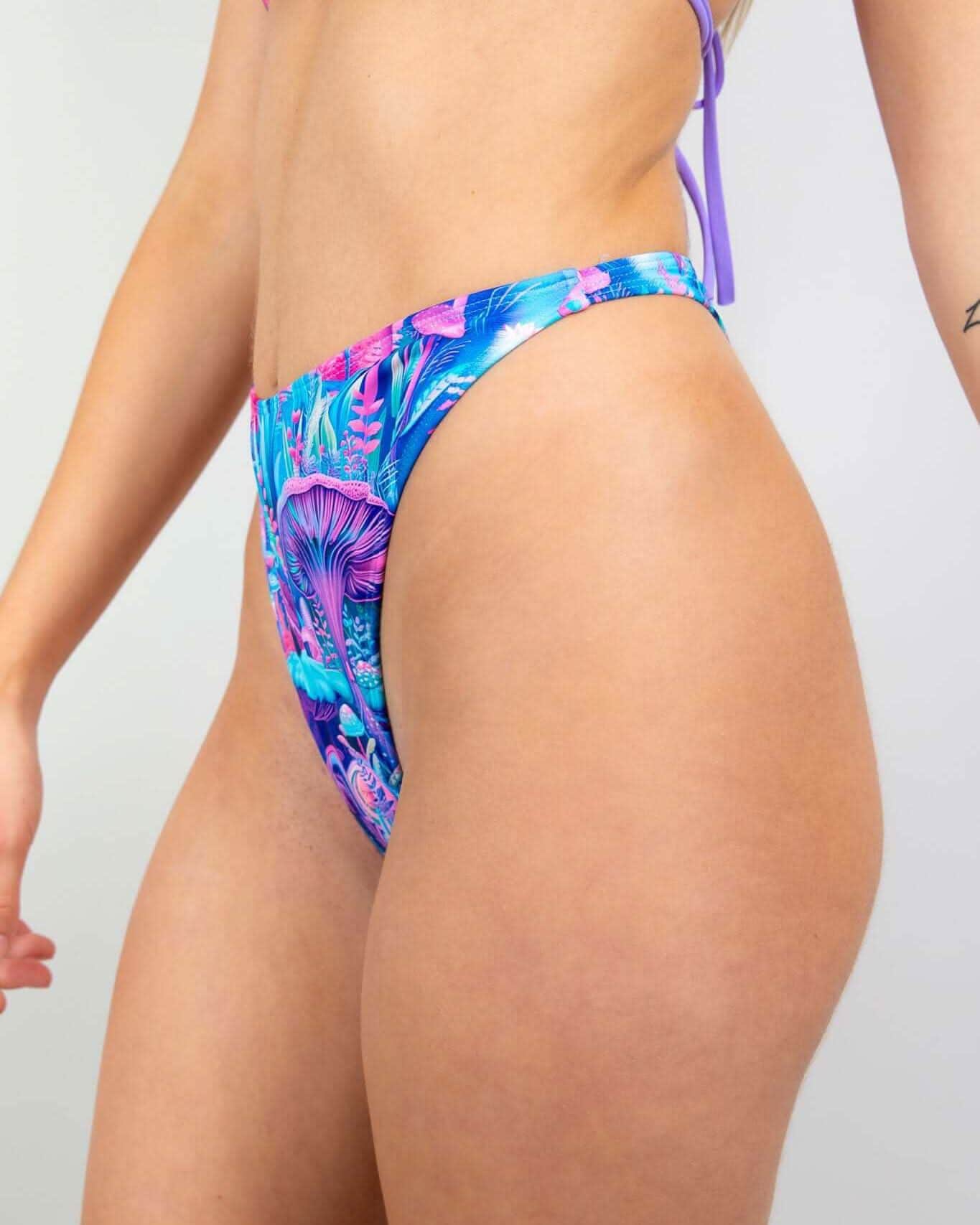 Fairycore Retro Thong Bottoms in vibrant blue, pink, and purple with a whimsical mushroom print, perfect for rave outfits.