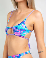 Colorful cutout bikini top in blue and purple floral patterns, perfect for summer beachwear and pool parties.