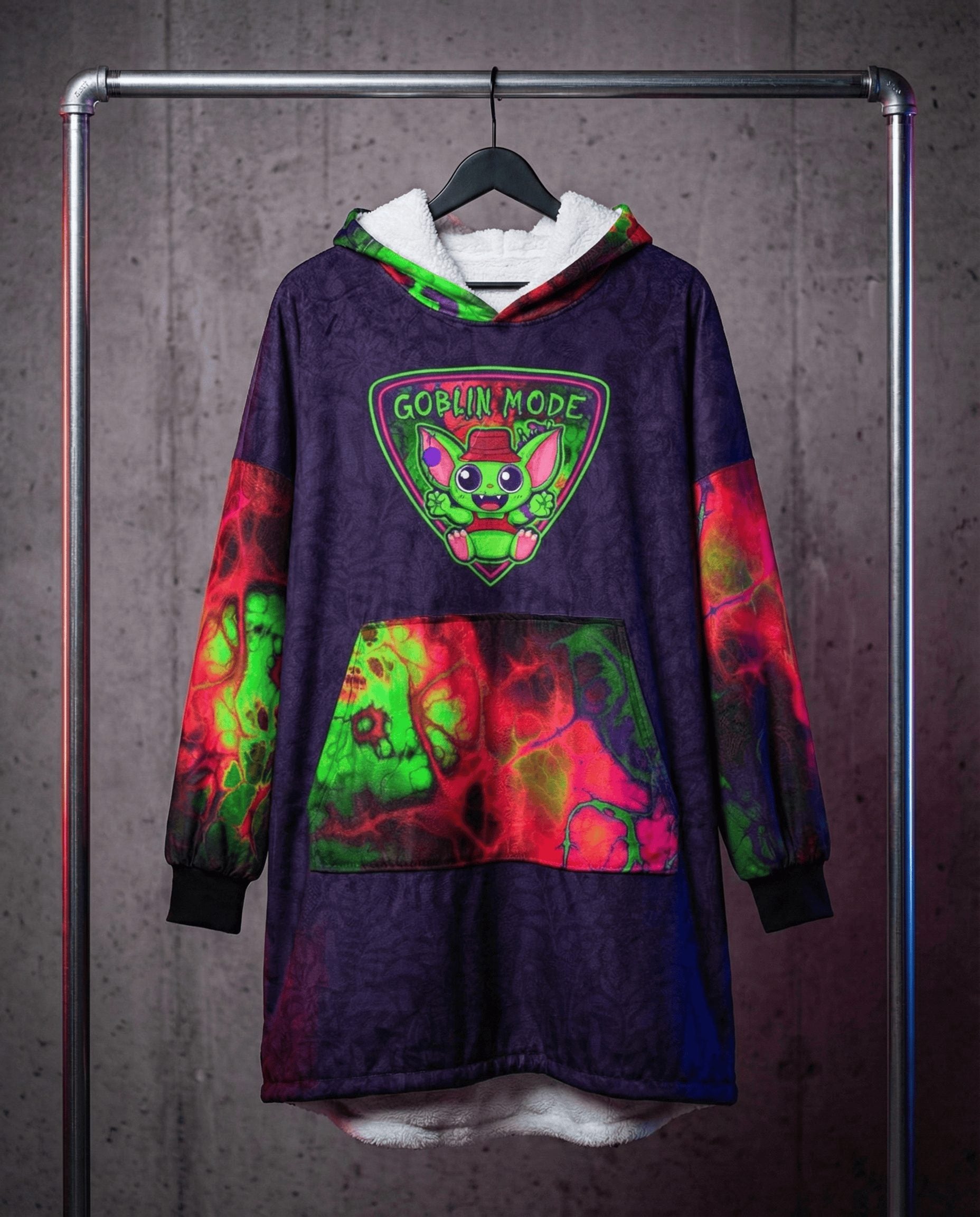 Festival hooded blanket in purple tie-dye with Goblin Mode graphic hanging on rack, rave recovery gear front view