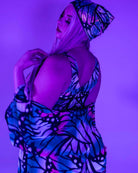 Model showcasing a holographic butterfly bandana in vibrant colors, perfect for rave outfits and festival clothing.