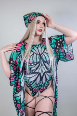 Model wearing a colorful butterfly print rave outfit and matching bandana, embodying festival style.