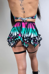 Model wearing a colorful Flutter Fairy Skirt with butterfly design, perfect for rave outfits and whimsical occasions.