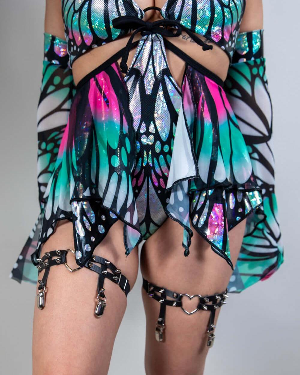 Model wearing a colorful Flutter Fairy Skirt with butterfly design, perfect for rave outfits and whimsical fashion.