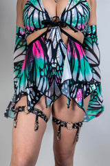 Model wearing a colorful Flutter Fairy Skirt with butterfly design, perfect for rave outfits and whimsical fashion.