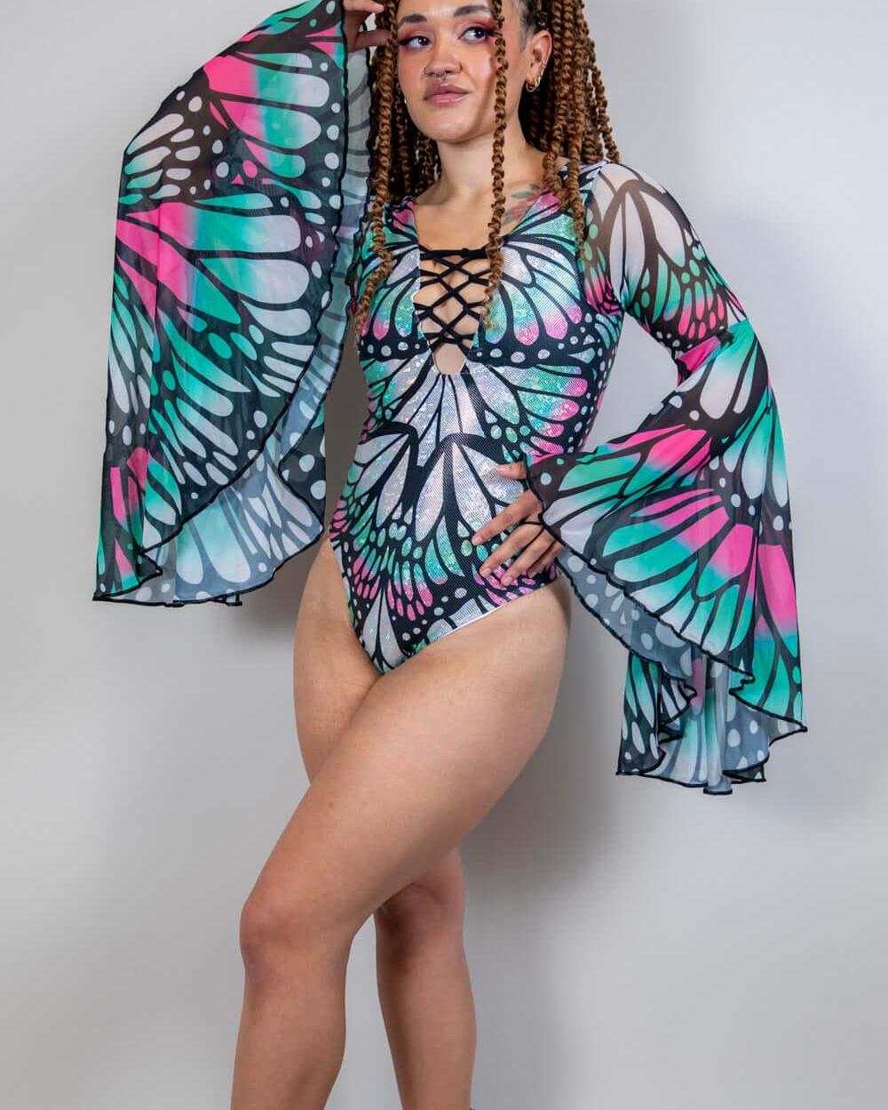 Model wearing the Flutter Goddess Bodysuit with butterfly pattern and flowy bell sleeves, perfect for rave outfits.