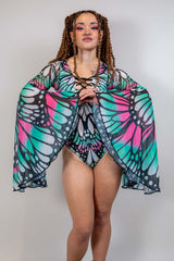 Model showcasing the Flutter Goddess Bodysuit with butterfly pattern and flowy bell sleeves, perfect for rave outfits.