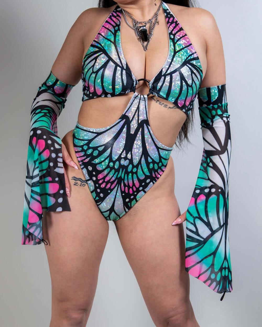 Model wearing a vibrant Flutter O-Ring Bodysuit with bold butterfly colors, perfect for rave outfits.