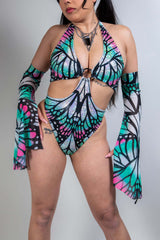 Model wearing a vibrant Flutter O-Ring Bodysuit with bold butterfly colors, perfect for rave outfits.