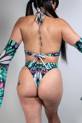 Model wearing Flutter O-Ring Bodysuit, showcasing a butterfly print, high waist thong and stylish arm sleeves.