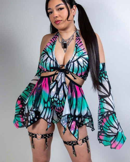 Model wearing a colorful Flutter O-Ring Bodysuit with butterfly print, perfect for rave outfits and versatile clothing.