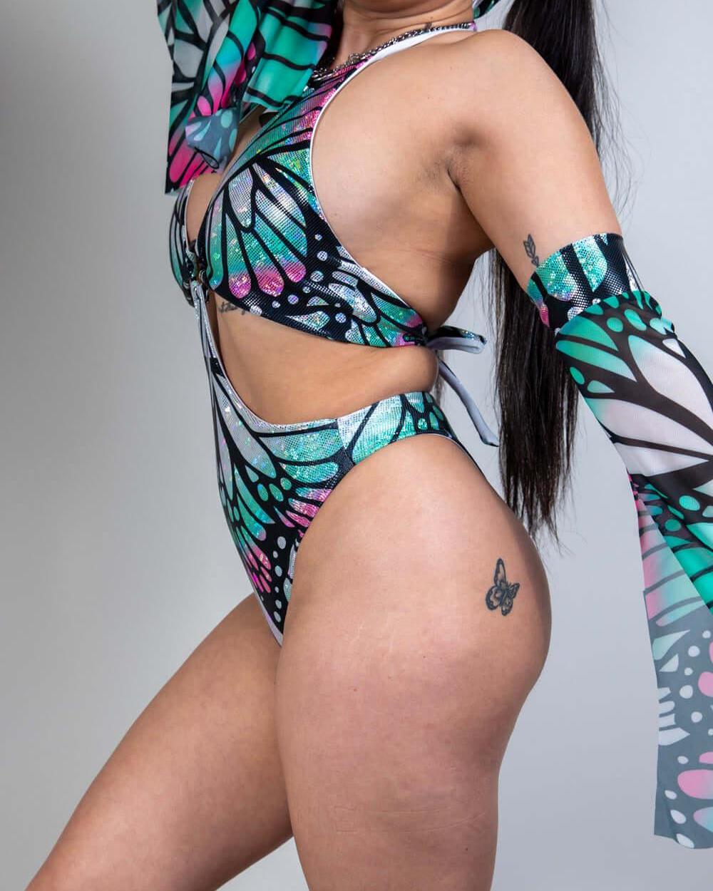 Model showcasing the Flutter O-Ring Bodysuit, vibrant butterfly design, perfect for rave outfits.