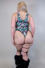 Back view of a woman in a Flutter Sideboob Bodysuit with leg straps and butterfly print, ideal for rave outfits.