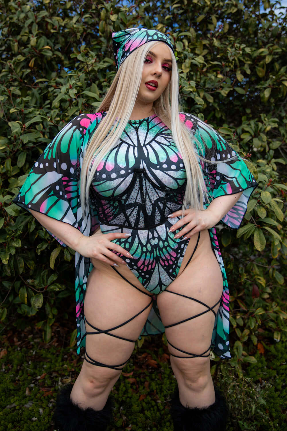 Model showcasing Flutter Sideboob Bodysuit with leg straps and butterfly print, perfect for rave outfits and clothing.